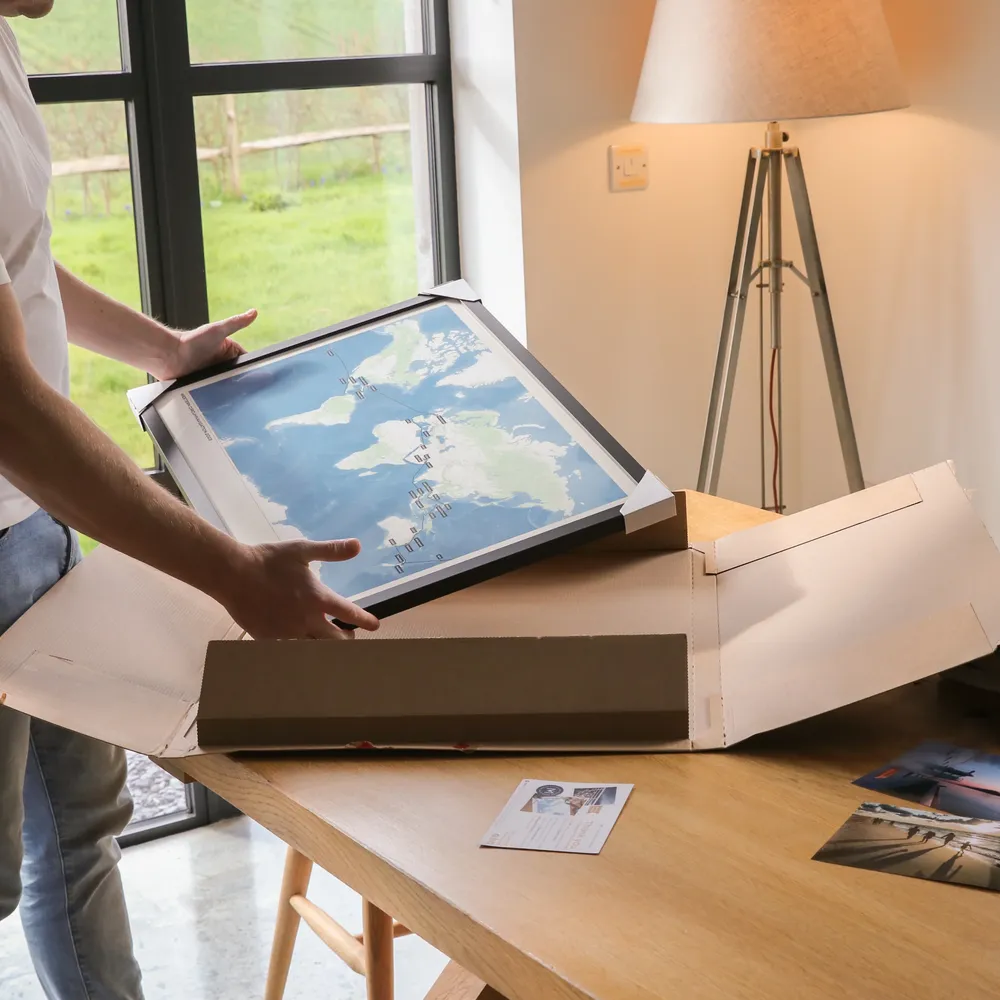 A framed print map of a cruise being unboxed
